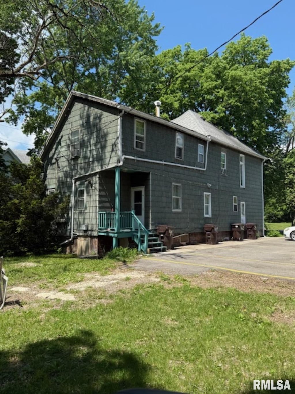 rear view of property featuring a yard