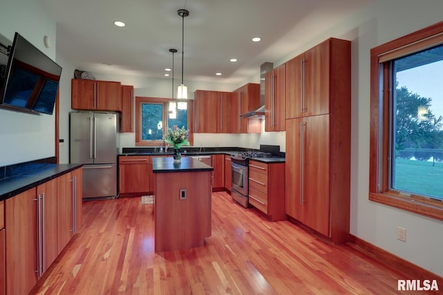 6 Marty Ln, Macomb, IL 61455 - kitchen with appliances with stainless steel finishes, dark countertops, wall chimney exhaust hood, a center island, and light wood finished floors
