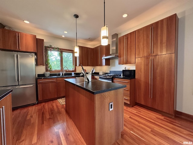 6 Marty Ln, Macomb, IL 61455 - kitchen with appliances with stainless steel finishes, wall chimney exhaust hood, dark countertops, light wood-type flooring, and a center island