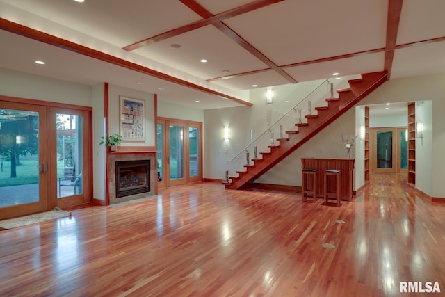 6 Marty Ln, Macomb, IL 61455 - unfurnished living room featuring recessed lighting, french doors, stairway, and wood finished floors