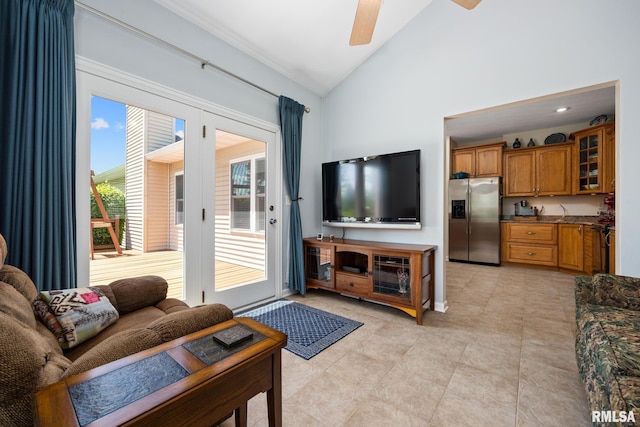 living room featuring ceiling fan, baseboards, high vaulted ceiling, and light tile patterned flooring