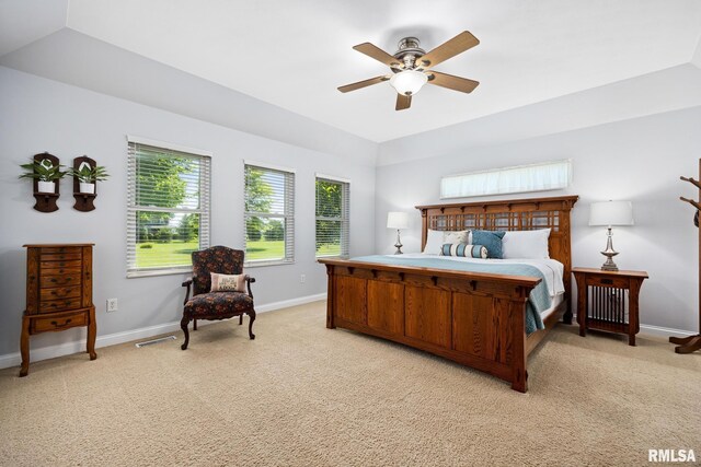 bedroom featuring light colored carpet, baseboards, and a ceiling fan
