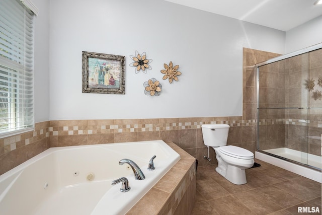 bathroom featuring toilet, a stall shower, a whirlpool tub, tile patterned flooring, and tile walls