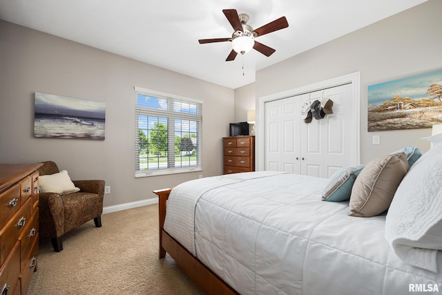 bedroom with carpet floors, baseboards, a closet, and a ceiling fan