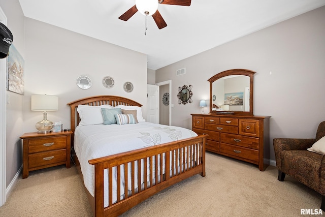 bedroom featuring light carpet, ceiling fan, and baseboards