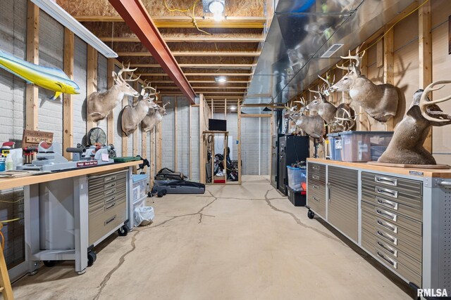 unfinished basement featuring a workshop area