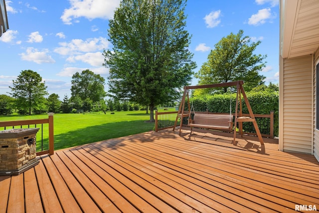 wooden deck featuring a yard and view of scattered trees