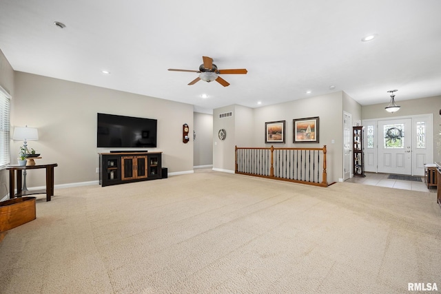 unfurnished living room with a ceiling fan, baseboards, light colored carpet, and recessed lighting