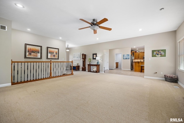 unfurnished room with a ceiling fan, recessed lighting, light colored carpet, and baseboards