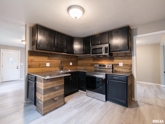 246 Herget St, Pekin, IL 61554 - kitchen featuring stainless steel appliances, a sink, light wood-style flooring, and baseboards