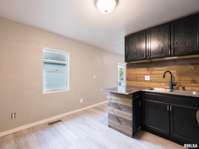 246 Herget St, Pekin, IL 61554 - kitchen featuring a sink, light wood finished floors, and baseboards