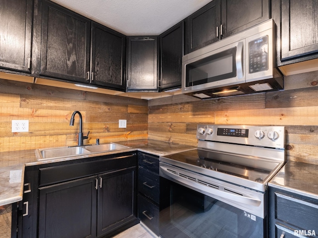 246 Herget St, Pekin, IL 61554 - kitchen featuring appliances with stainless steel finishes, a sink, and dark cabinetry