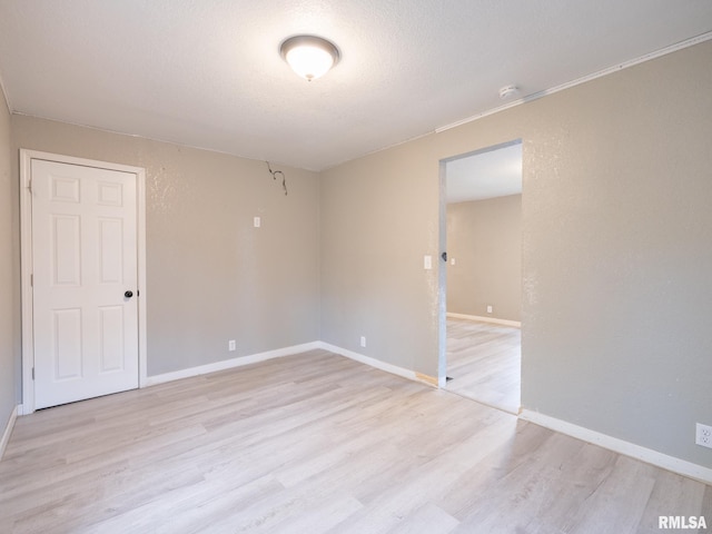 246 Herget St, Pekin, IL 61554 - empty room with light wood-style floors, a smoke detector, and baseboards