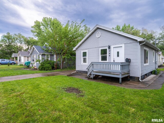 246 Herget St, Pekin, IL 61554 - view of front of home with a deck and a front lawn