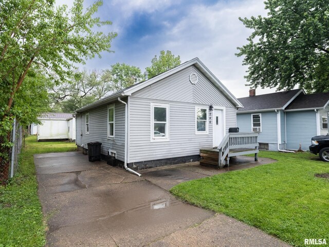 246 Herget St, Pekin, IL 61554 - view of front of home featuring a front lawn, an outdoor structure, and a storage shed