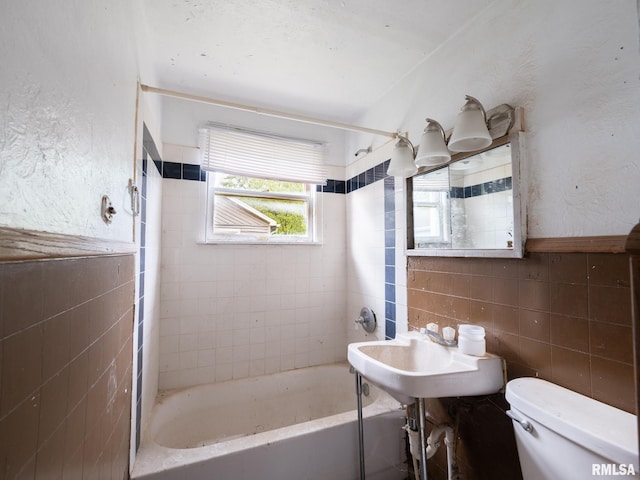 246 Herget St, Pekin, IL 61554 - full bathroom featuring tile walls, toilet, shower / washtub combination, and a sink