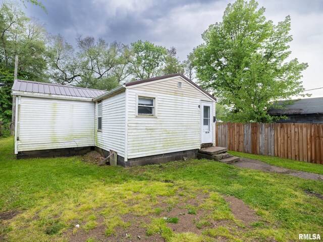 246 Herget St, Pekin, IL 61554 - back of property with entry steps and metal roof