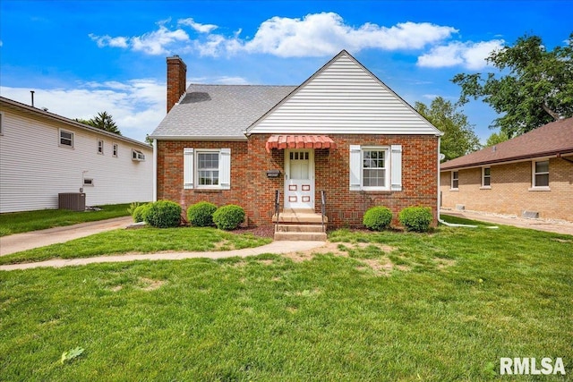 2309 W Manor Pkwy, West Peoria, IL 61604 - bungalow with a chimney, a front lawn, and brick siding