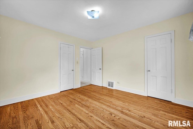 2309 W Manor Pkwy, West Peoria, IL 61604 - unfurnished bedroom featuring baseboards and light wood-type flooring