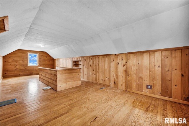 2309 W Manor Pkwy, West Peoria, IL 61604 - additional living space featuring wood walls, light wood-type flooring, and lofted ceiling