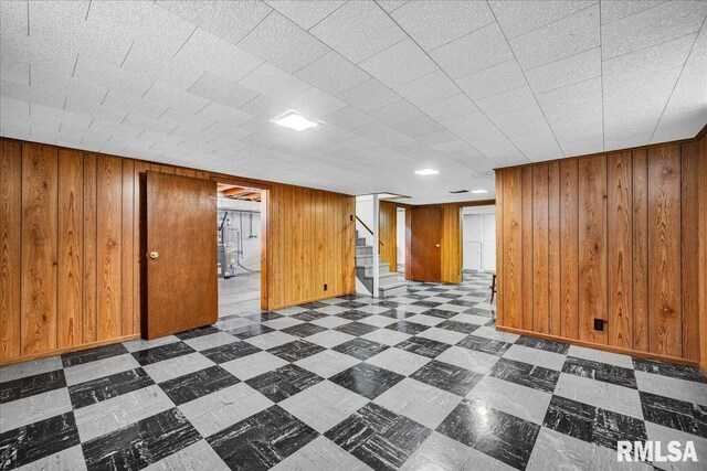 2309 W Manor Pkwy, West Peoria, IL 61604 - finished below grade area featuring tile patterned floors, stairway, and wood walls