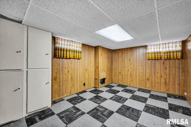 2309 W Manor Pkwy, West Peoria, IL 61604 - basement with tile patterned floors, a paneled ceiling, and wood walls
