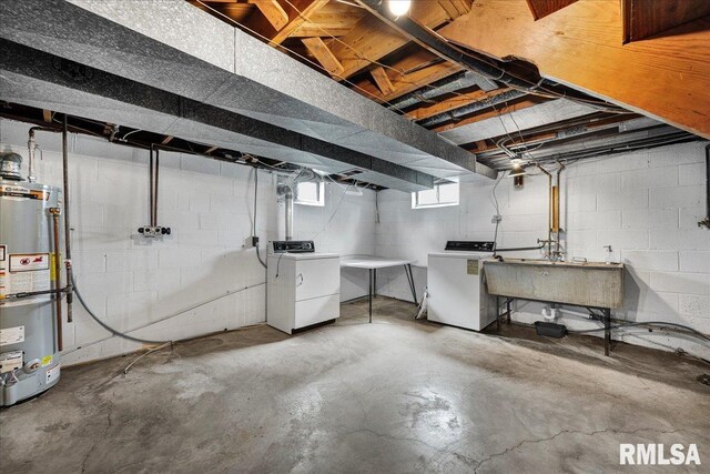 2309 W Manor Pkwy, West Peoria, IL 61604 - basement with gas water heater, washer and clothes dryer, and a sink