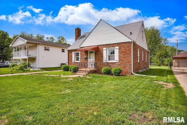 2309 W Manor Pkwy, West Peoria, IL 61604 - bungalow-style home featuring brick siding, a chimney, and a front lawn