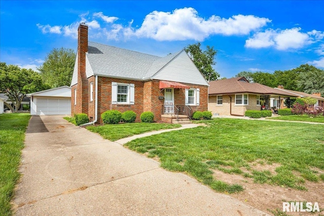 2309 W Manor Pkwy, West Peoria, IL 61604 - view of front of home with brick siding, a chimney, a detached garage, a front yard, and an outdoor structure