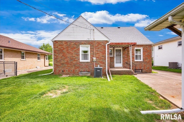 2309 W Manor Pkwy, West Peoria, IL 61604 - back of house featuring brick siding, central AC unit, and crawl space