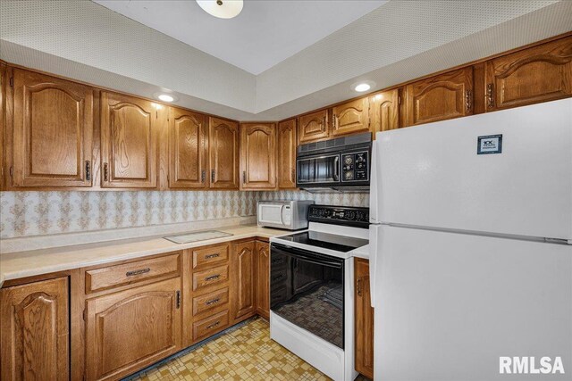 2309 W Manor Pkwy, West Peoria, IL 61604 - kitchen featuring white appliances, brown cabinets, light countertops, and recessed lighting