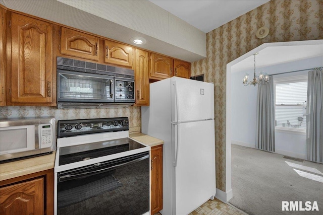 2309 W Manor Pkwy, West Peoria, IL 61604 - kitchen with white appliances, wallpapered walls, a chandelier, brown cabinets, and light countertops