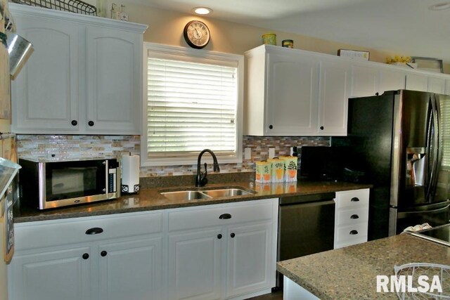 kitchen featuring black appliances, a sink, white cabinets, and backsplash