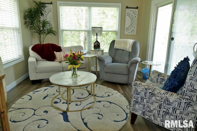 living area with wood finished floors and baseboards