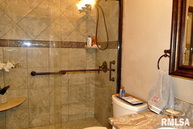 full bathroom featuring a shower stall and toilet