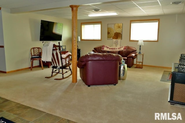 living area featuring carpet flooring, decorative columns, baseboards, and a paneled ceiling
