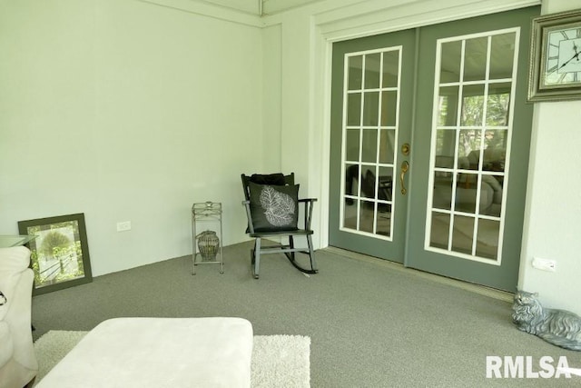sitting room featuring french doors and carpet floors