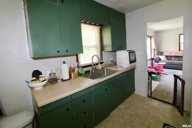 109 N 19th St, Pekin, IL 61554 - kitchen featuring a sink, green cabinetry, light countertops, and light floors