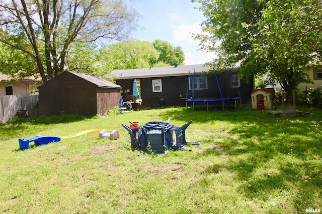 109 N 19th St, Pekin, IL 61554 - rear view of property featuring a trampoline, a storage shed, and an outdoor structure
