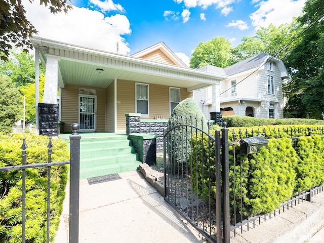 1218 N Sheridan Rd, Peoria, IL 61606 - bungalow with covered porch, a gate, and fence