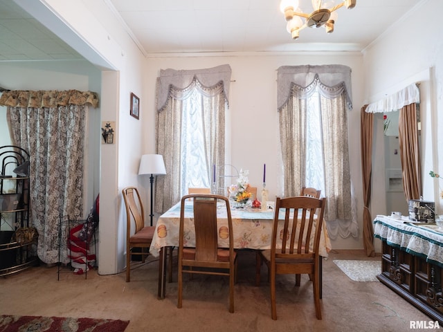1218 N Sheridan Rd, Peoria, IL 61606 - carpeted dining space with a chandelier and crown molding