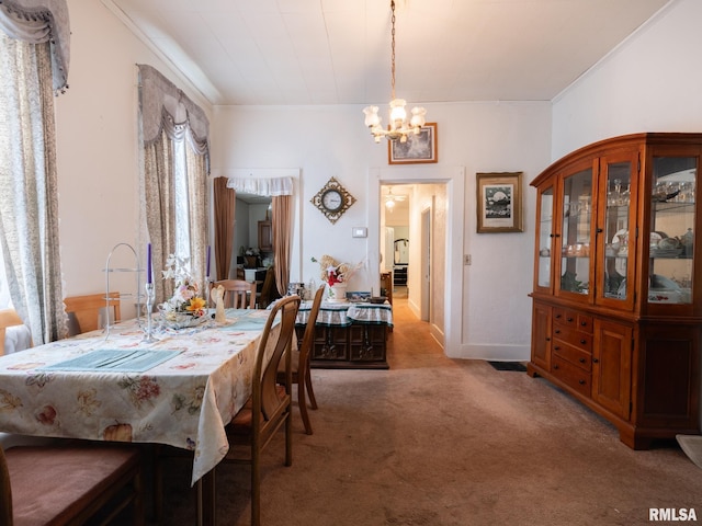1218 N Sheridan Rd, Peoria, IL 61606 - dining space with carpet floors, ornamental molding, and a chandelier