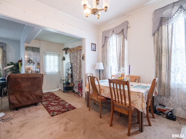 1218 N Sheridan Rd, Peoria, IL 61606 - dining area with a chandelier, light carpet, and crown molding
