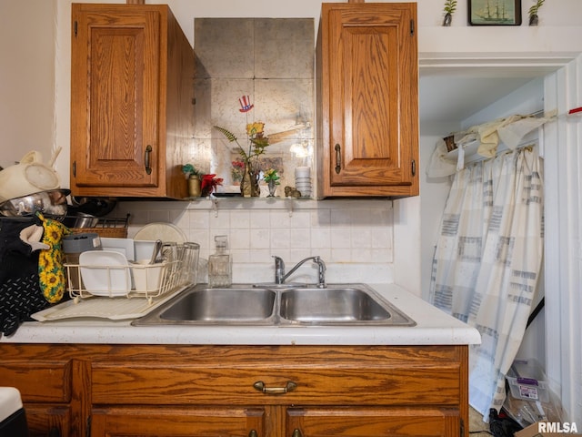 1218 N Sheridan Rd, Peoria, IL 61606 - kitchen featuring brown cabinets, a sink, and light countertops