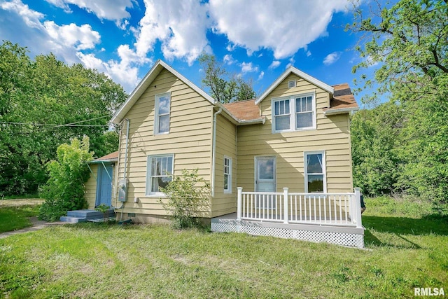 view of front of house with a front lawn and a deck