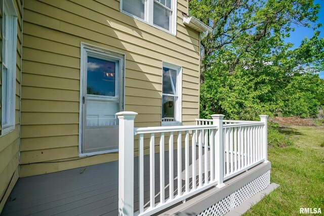 wooden deck with a lawn