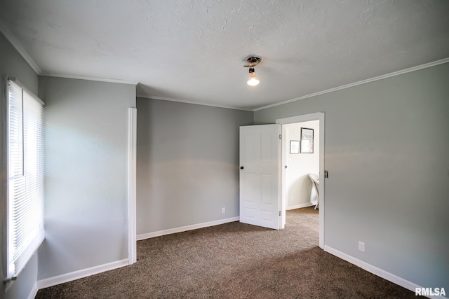 empty room featuring carpet floors, crown molding, baseboards, and a textured ceiling