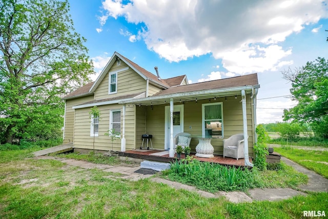 view of front of home with covered porch and roof with shingles