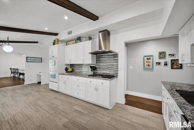 153 Spring Creek Ter, East Peoria, IL 61611 - kitchen with wall chimney exhaust hood, stone counters, white cabinets, beam ceiling, and double oven