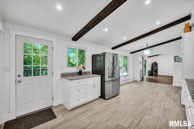 153 Spring Creek Ter, East Peoria, IL 61611 - kitchen with stainless steel fridge, healthy amount of natural light, white cabinets, recessed lighting, and light stone countertops